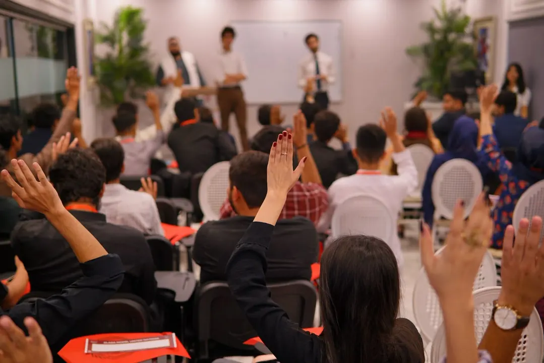 Delegates raising their hands during a session